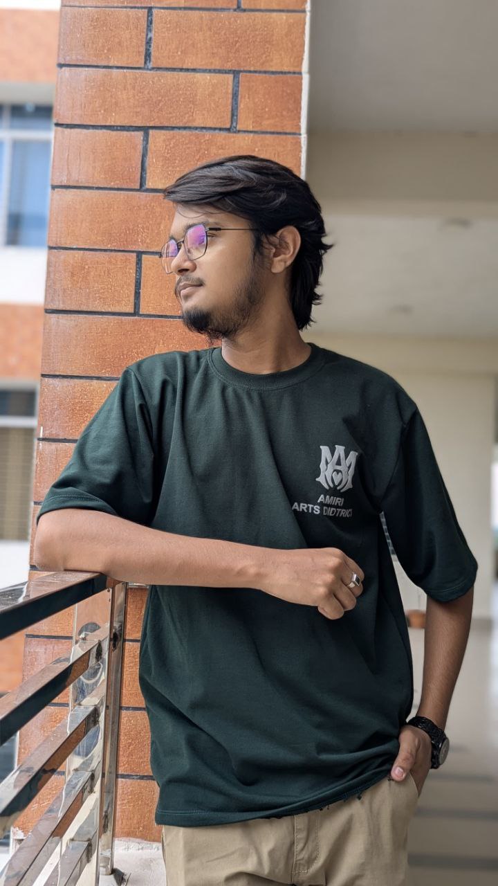 Portrait wearing green T-shirt on a tree-lined road